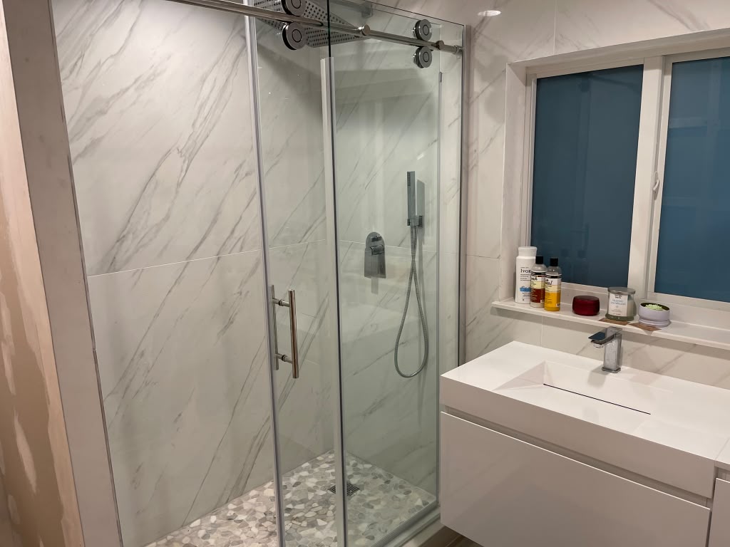 After: bathroom with corner shower replaced by marble porcelain walk-in shower
