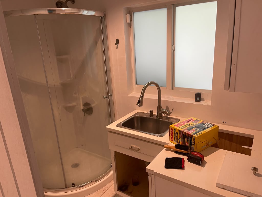 Before: bathroom with corner shower replaced by marble porcelain walk-in shower