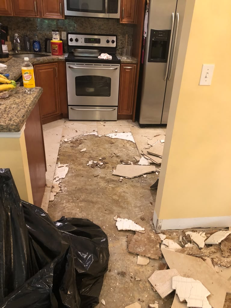 Before: kitchen floor demolished and then finished in polished porcelain tile