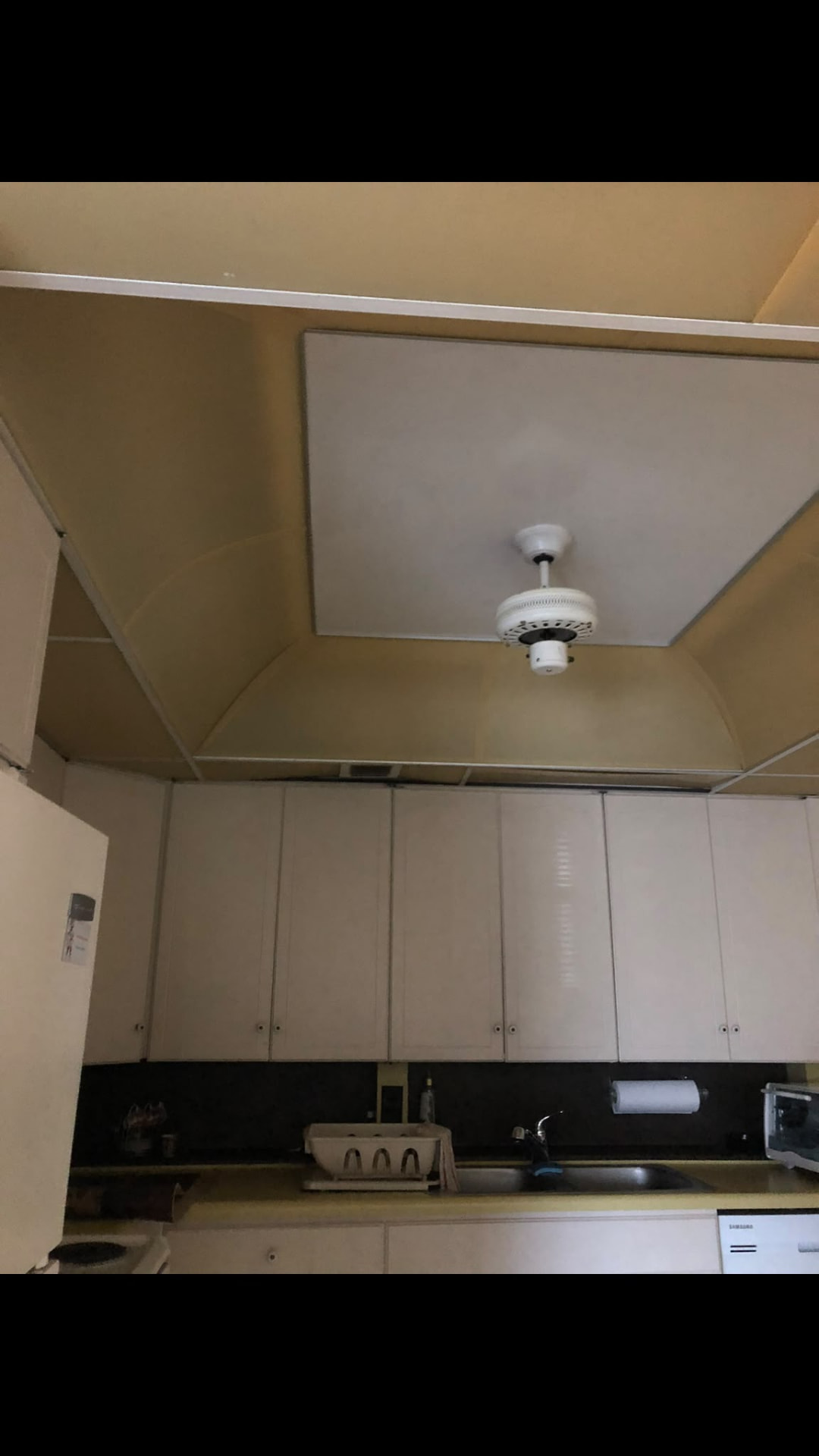 Before: kitchen with white cabinets and new granite counters