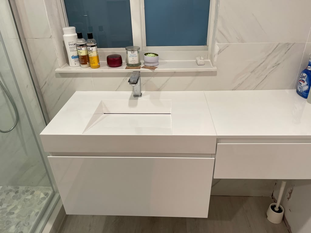 Finished bathroom with floating vanity and marble tile