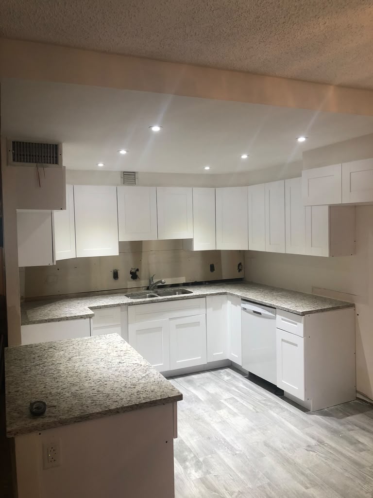 Finished kitchen with white shaker cabinets